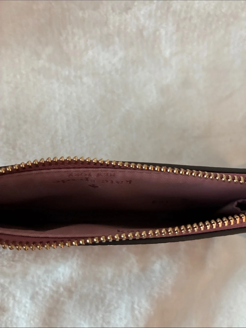 kate spade pebbled leather wristlet in dusty rose with gold logo